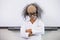 Boy dressed as scientist standing in classroom