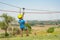 A boy dressed in a protective helmet and insurance, goes down the rope, descends holding a protective cable