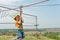 A boy dressed in a protective helmet and insurance, goes down the rope, descends holding a protective cable