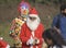 A boy dressed in Santa clause dress begs in the kolkata maidan on christmas