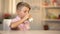 Boy drinking fresh organic milk from glass on table, morning energy food, dairy