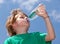 Boy drinking fresh water outdoors