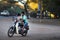 Boy driving a motorcycle with his dog in Bago, Myanmar