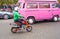 Boy driving with tiny orange motorbike