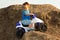 Boy driving toy quad on terrain