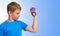 Boy with dumbbells looking at the bicep muscle