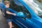Boy earning pocket money cleaning blue compact car