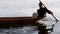 Boy earns living as fisherman in a lake using boat
