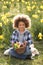 Boy On Easter Egg Hunt In Daffodil Field