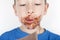 Boy eat chocolate in front of a white background