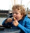 Boy eating Fish in Harbour