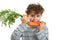 Boy eating fresh carrot