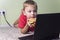 Boy eating a hamburger and playing