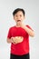 Boy eating a jelly baby from a bowl of mixed colored lollies candy