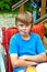 Boy eating outside at a table