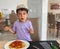 boy eating pasta sitting in a restaurant. portrait. he didn\\\'t like it