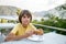 The boy is eating waffles in a street cafe at the sea