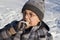 Boy eating winter cookies,boy in glasses eating gingerbread in winter outdoors