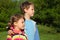 Boy embraces girl for shoulder outdoor