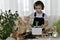 The boy is engaged of hyacinths, adds ground shoulder blade to the flower pot focused looking at his work