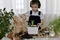 The boy is engaged of hyacinths, adds ground to the flower pot with bulbs