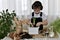 The boy is engaged of hyacinths, concentrated on the distribution of three flower bulbs in a flower pot