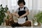 The boy is engaged of hyacinths, hands plants the bulb in a flower pot in the ground.