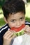 Boy enjoying a red juicy watermelon