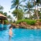 Boy enjoying a tropical swimming pool