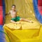 Boy enjoying a wet inflatable slide