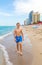 Boy enjoys walking along the beach