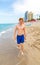 Boy enjoys walking along the beach