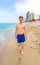 Boy enjoys walking along the beach