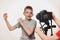 Boy enthusiastically talks to the camera. Children`s hands with a camera in the frame. Young video blogger. White background