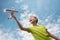 A boy of European appearance with an airplane against the sky with clouds. Bright emotions. Summer mood