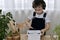 The boy, examines the gardening equipment, the small rake in his hand, is engaged in the planting of hyacinths