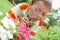 Boy, examining with a magnifying glass flower