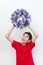 Boy excited while holding purple Christmas wreath.