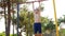 Boy exercising on chin-up bar at outdoor sports ground