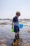 Boy exploring tide pools on New Hampshire coast