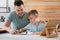 Boy with father doing homework at table