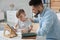 Boy with father doing homework at table indoors