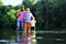 Boy with father and grandfather fly fishing outdoor over river background. Fishing. Father, son and grandfather on