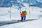 Boy and a father on the ski moving walkway belt at skiing school