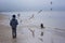 Boy feeding gulls on the beach. Little boy stands on beach the sea on cold windy day