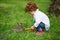 Boy feeding rabbit with carrot in park