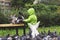 Boy feeds hungry pigeons park bench spring