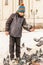 The boy feeds the pigeons on his hands, standing on the square