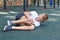 Boy fell and hit on outdoor playground. knee injury child sports injury