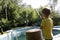 Boy filling pool with water